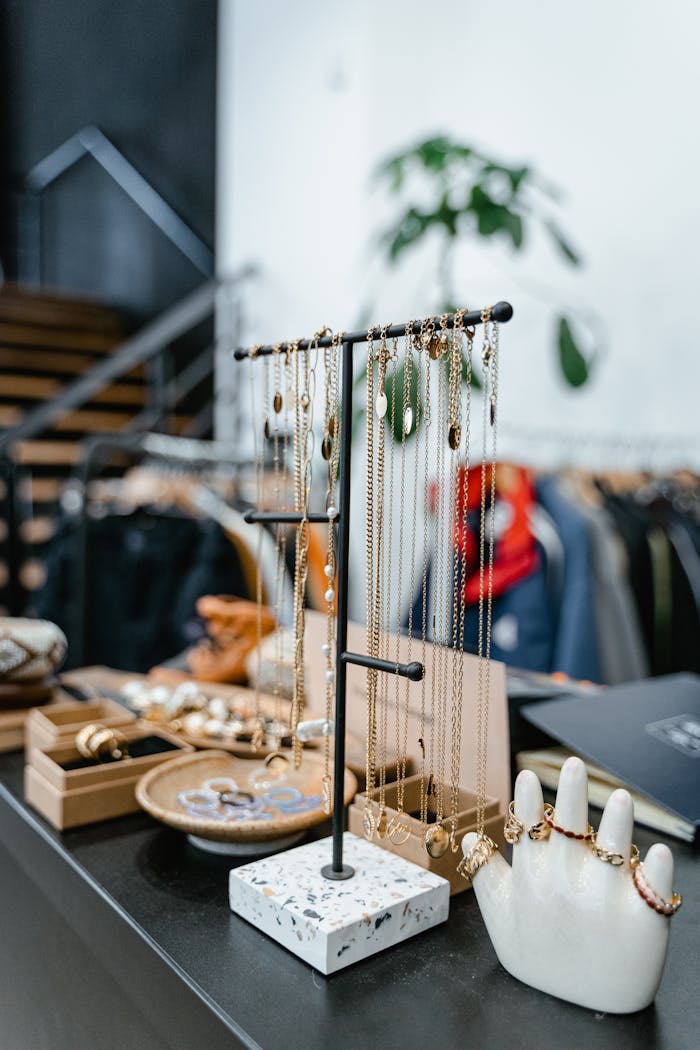 Chic jewelry presentation in a stylish boutique setting with necklaces and rings on display.